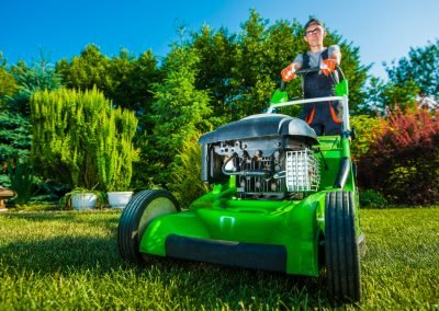 A man mowing the grass with a push lawn mower