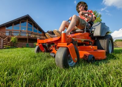 Man riding a zero turn lawn mower