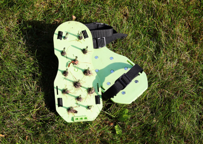 A photo of a pair of lawn aeration shoes