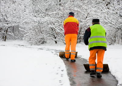 Workers shoveling a path through snow